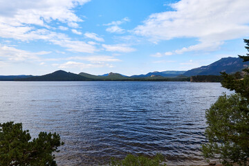 view of the lake and the silhouette of the mountains in the background