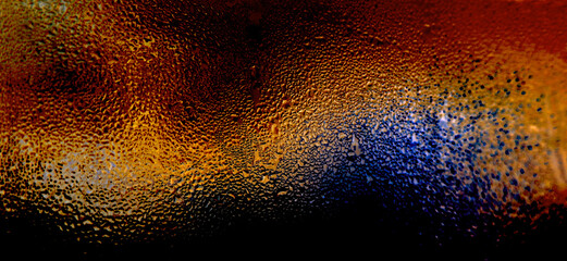 Fototapeta na wymiar colorful dew drops on the glass