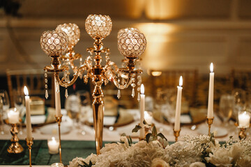 Table set up for a special event with roses and greenery indoor Wedding table decorated with...