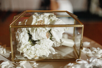 Transparent cards box for cards and gifts on the table White flowers Bridal bouquet inside it Close up Wedding details