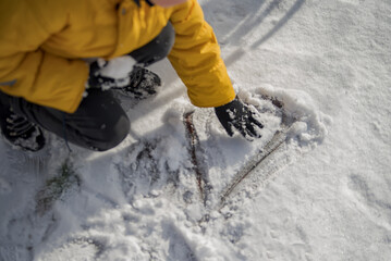 Top view, hand-drawn a heart shape on natural pure white soft snow surface in a cold weather day