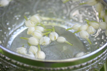Jasmine flowers soaked in water in a bowl