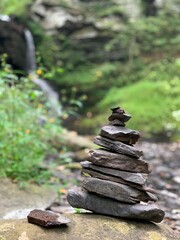 stack of stones in the forest, zen stones at waterfall