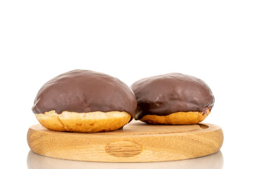 Two flavored chocolate donuts on a wooden tray, macro, isolated on a white background.