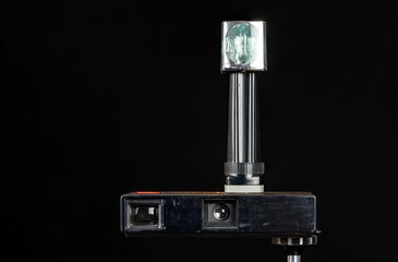 Old, dusty, analogue pocket camera with flash cube, photographic technology from the last millennium.