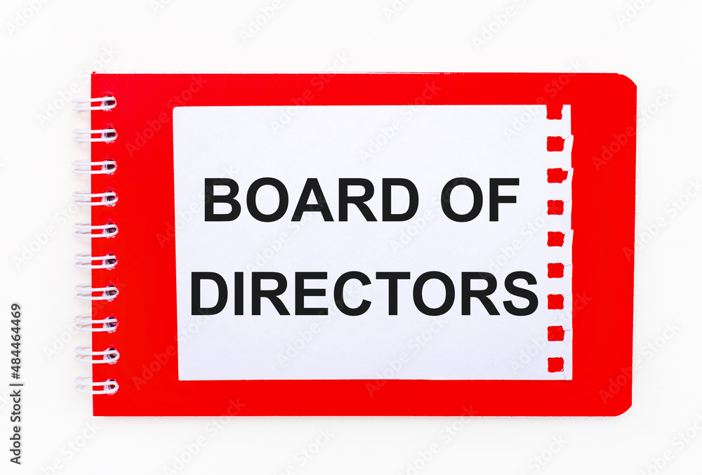 Poster on a white background - a bright red notebook on a spiral. on it is a white sheet of paper with the 