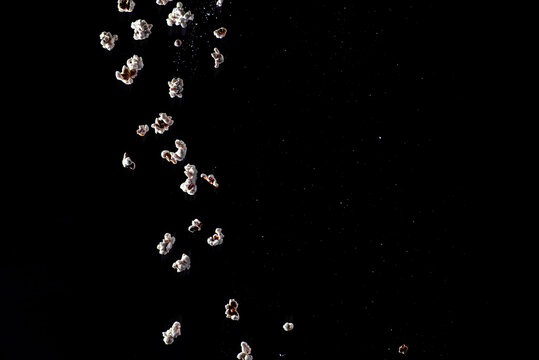 falling popcorn on a black background - Powered by Adobe