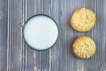 Kefir (yogurt) and two sticks. Breakfast or dinner, dairy products baked goods.