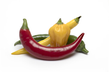 Closeup different colored chili peppers white background
