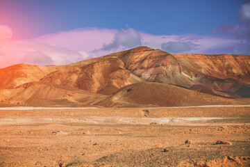 Evening cloudy sky over mountain desert. Negev desert in Israel at sunset - obrazy, fototapety, plakaty