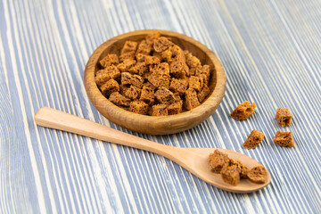 Croutons in a wooden bowl on the table.