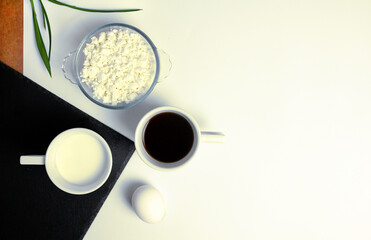 Natural products for breakfast: cottage cheese, egg, kefir, black coffee. Black and white contrast....