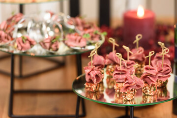 Set of beautiful canapes on skewers for buffet table. Cheese and ham on skewers. Close-up, selective focus.