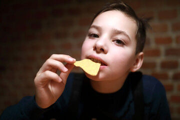 Child eating nachos in restaurant