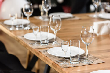 Glass dishes on a wooden table. clean and empty. cozy atmosphere. serving a banquet