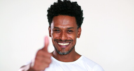 Smiling African black guy portrait being positive giving thumb up with approval