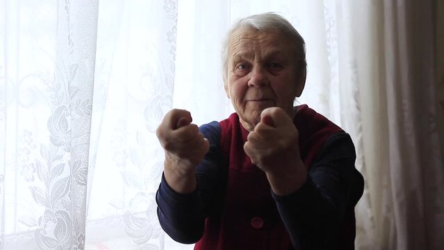 Elderly woman showing an obscene hand gesture