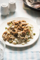Chicken shoarma with mushrooms in creamy sauce served with rice and peas