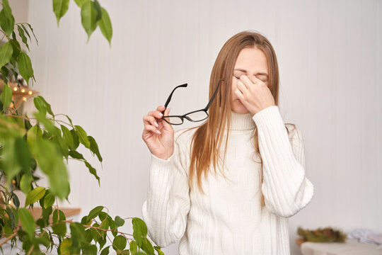 Young woman at office. Tired eyes. Female stress lifestyle. New normal education. Sad emotion. Headache concept. Pretty face person. Exhausted worker pain