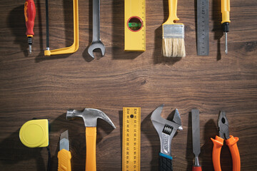 Work tools on the wooden background.