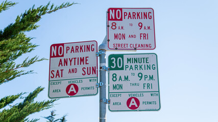 No parking signs in San Francisco, California. The three signs make it hard to understand for the visitors. No parking signs on a light pole