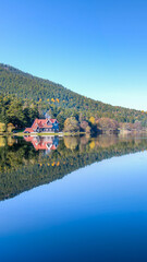 Fototapeta premium Panoramic view of Abant Lake with a wooden lake house in Abant, Golcuk, Bolu, Turkey