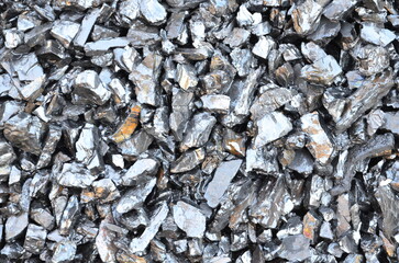 The texture of wet shiny anthracite coal is suitable as a background.