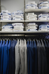 View of shelves and racks of shirts and wedding suits for grooms