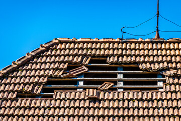 damaged roof at an old house - obrazy, fototapety, plakaty