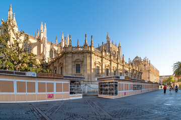 Christmas holiday market stalls and booths are closed at morning next to  the Great Cathedral of Seville in Seville, Spain. - Powered by Adobe