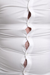 Man wearing tight shirt, closeup view. Overweight problem