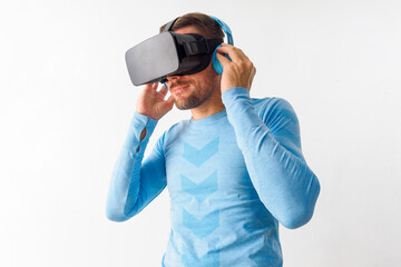 Man with VR headset and wireless headphones wearing sport clothing. Concept virtual reality sport.