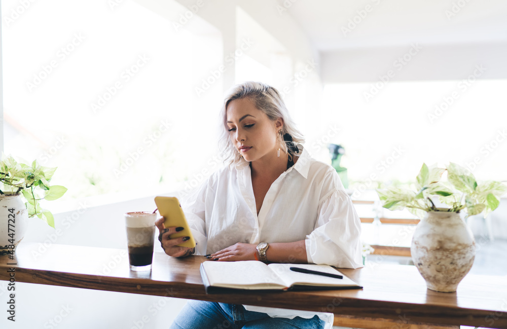 Poster caucasian woman with education textbook using cellphone technology browsing website content during t