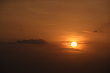 Bright colorful sunset sky with rays of setting sun and vivid dark clouds