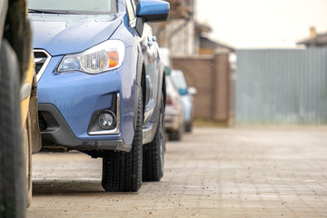 Cars parked in a row on a city street side