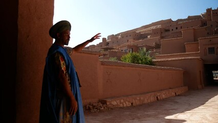 Berber guide showing the kasbah of Ait Ben Haddou