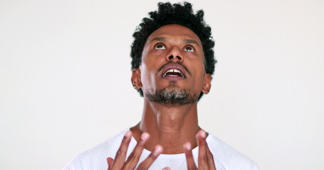 Frustrated anxious african man portrait emotional reaction, looking at the sky with despair and frustration