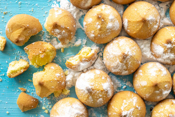 Shortbread cookies consisting of butter, flour, and jam filling, close-up view of a baked sweet cookie on a wooden background, top view
