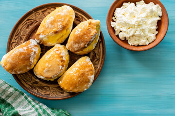 Baked cottage cheese pies. Homemade baking. Food on the table. Portion pies. Curd for stuffing. Country style
