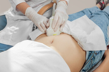 Young woman undergoing ultrasound scan in clinic