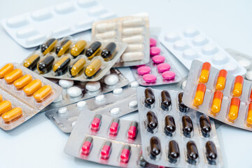 Tablets and medical capsules in a blister pack isolated on white background