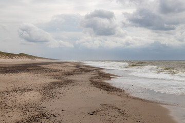 clouds over the beach at the north sea on a stormy day