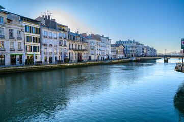 Obraz premium photography of petit bayonne from the quai Amiral Lespes we can see the river Nive and the buildings of the quai des Corsaires in the background the pont Marengo. A sunny winter morning with nobody on