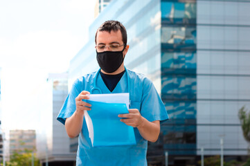 young male doctor with mask in front of hospital legend medical history