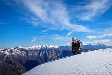 Portrait of girl on hike up the top of the snowy mountain.