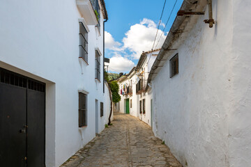 Fototapeta na wymiar One of the many narrow winding alleys of homes in the Pueblo Blanco, or White Village of Grazalema, in the Andalusian mountains of southern Spain.