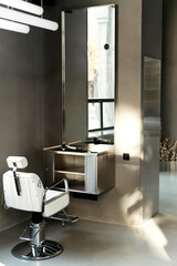 stylish armchair in the barbershop. red and white armchair in a beauty salon. barber work environment