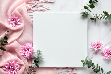 Mockup on blank square canvas. Fragrant eucalyptus twigs and pink chrysanthemum flowers on pink...