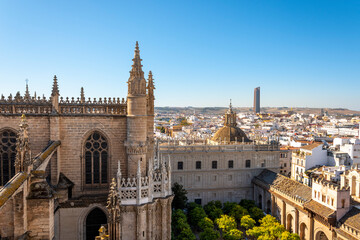 Fototapeta na wymiar City view from the Giralda Tower of the Great Seville Cathedral of the skyline, cathedral grounds and Sevilla or Pelli Tower in Seville, Spain.
