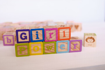 Word Girl Power written on wood block with colored letters.